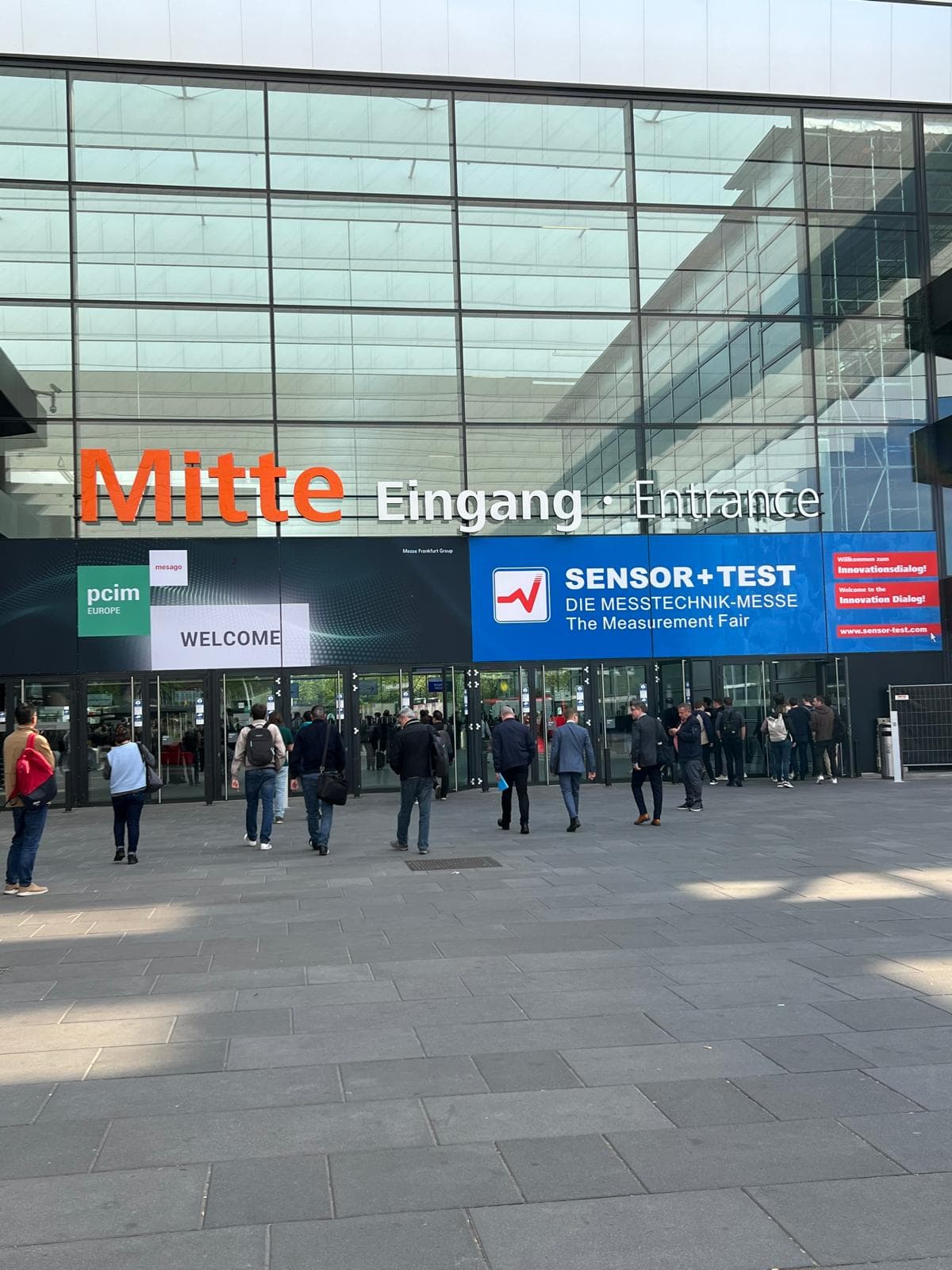 The Mitte entrance at Messe Nürnberg, with the PCIM Europe and SENSOR+TEST banners side by side above the doors.